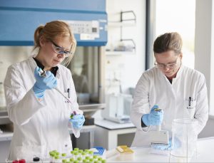 two female scientists sampling liquid from test tubes