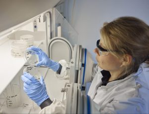 female scientist working with lab equipment