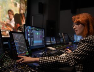 woman using computers and equipment for music or movie editing | Platinum Equity