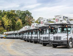 a line of tracks parked in a parking lot