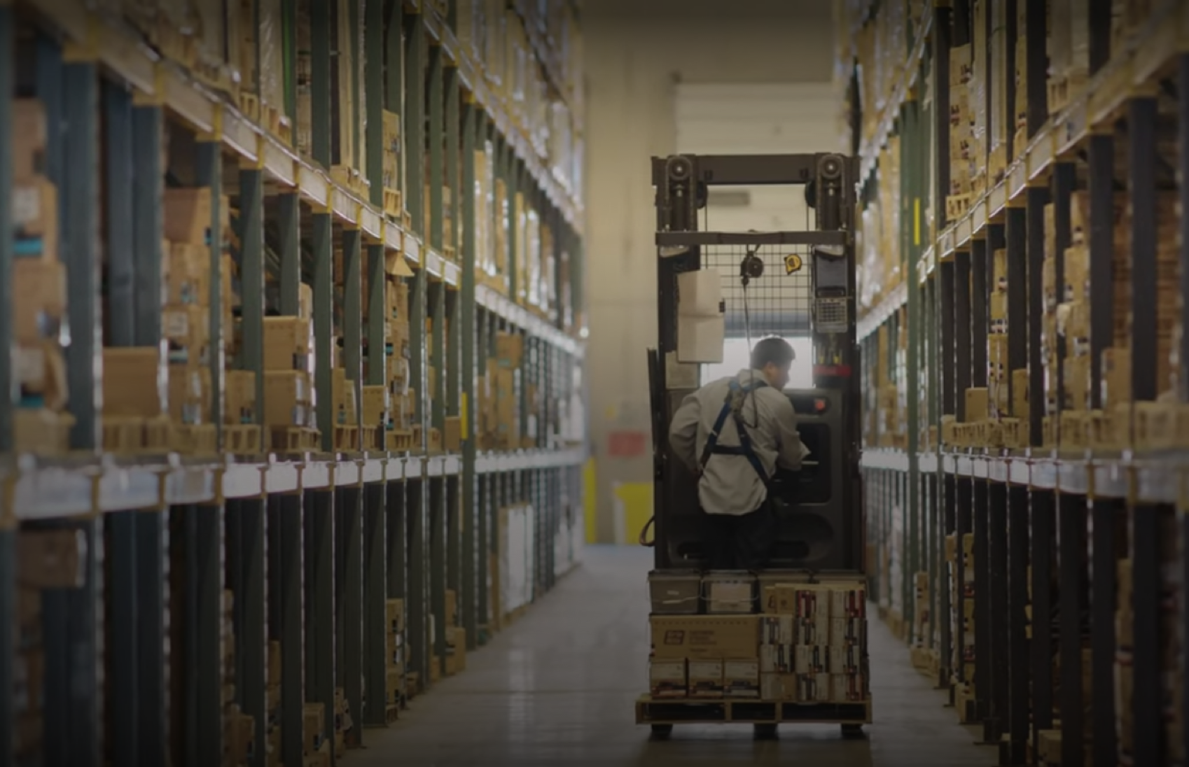 Man riding a cart inside the warehouse