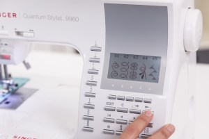 selecting button options on a sewing machine