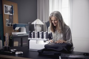 woman sewing a black fabric