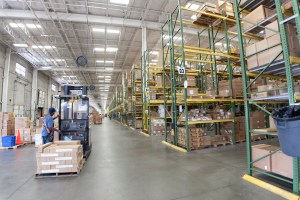 man operating a forklift in a storage warehouse | Platinum Equity