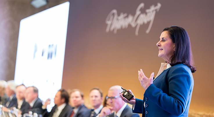 woman mid talk in Platinum Equity annual meeting
