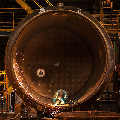 Man wielding inside a cylindrical steel