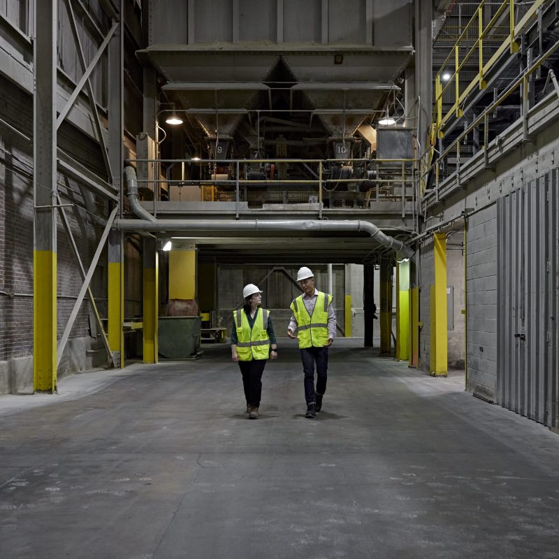 2 workers in vest in industrial setting