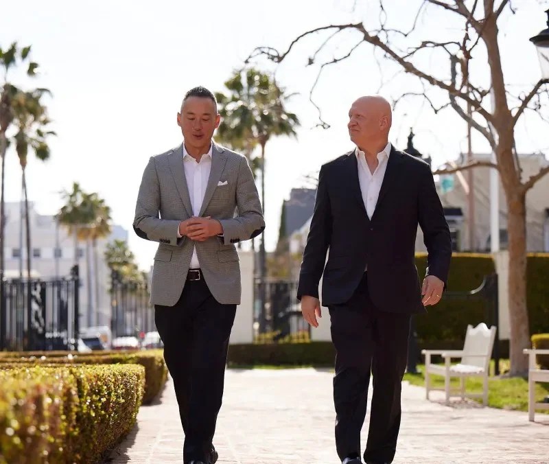 2 men in suites walking outside side by side