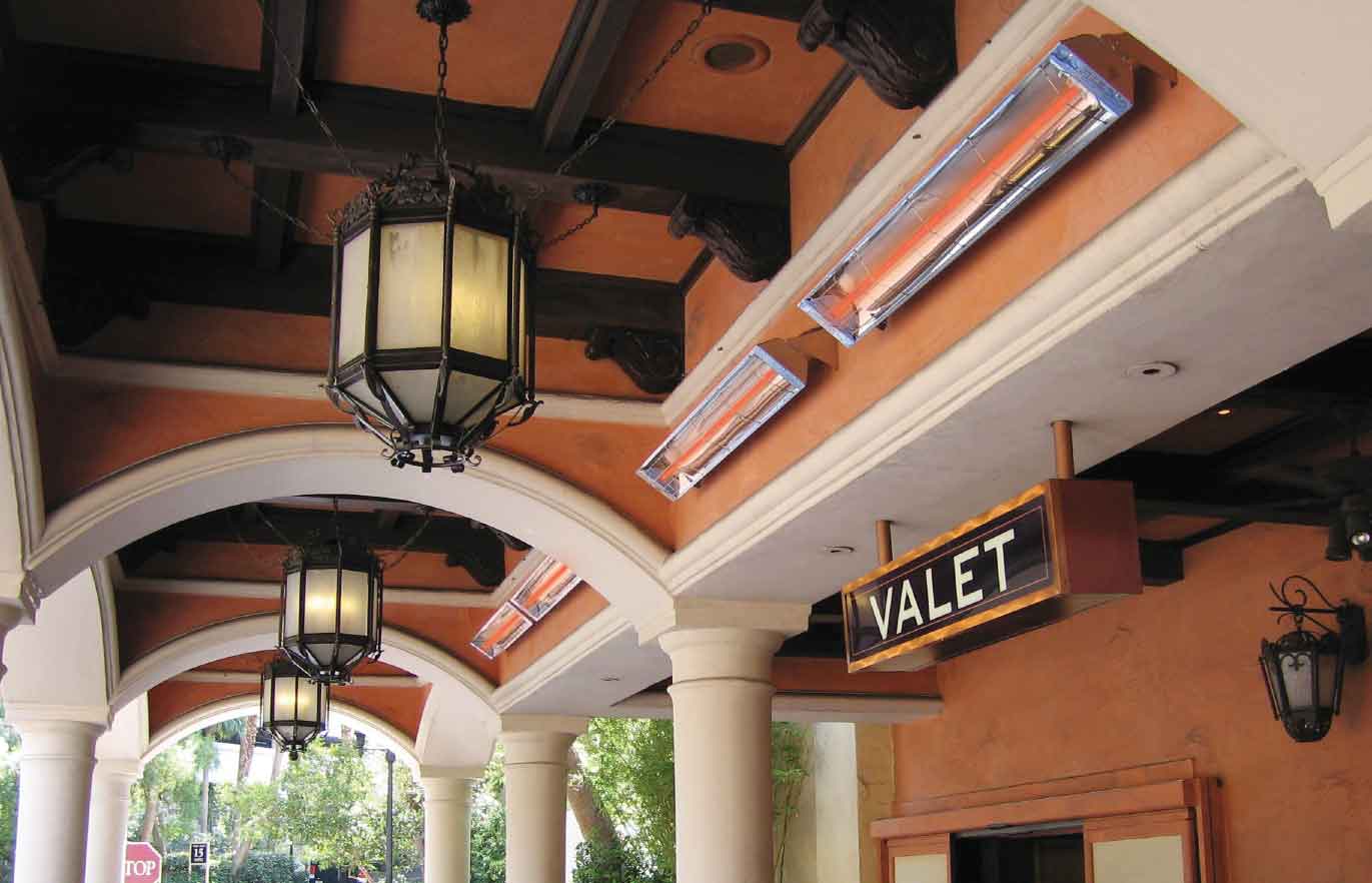 Covered valet entrance with arched walkways, hanging lanterns, white columns, and mounted infrared heaters beneath a decorative ceiling. | Platinum Equity